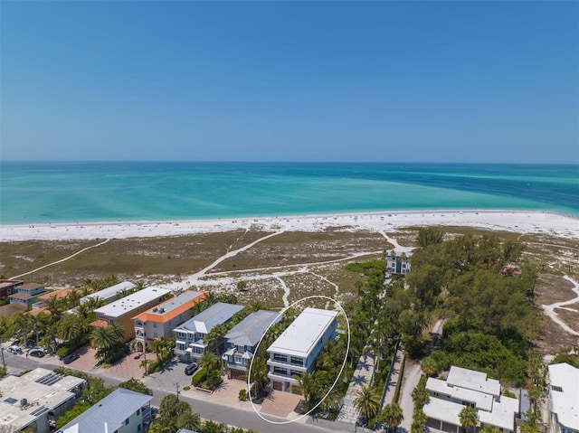 bird's eye view featuring a water view and a beach view