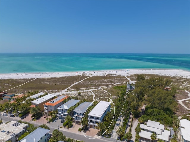 bird's eye view with a water view and a view of the beach