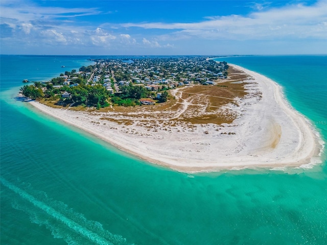 drone / aerial view featuring a water view and a view of the beach