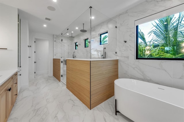 bathroom featuring vanity and shower with separate bathtub