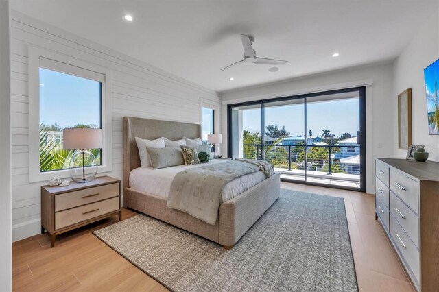 bedroom featuring light hardwood / wood-style flooring, ceiling fan, and access to exterior