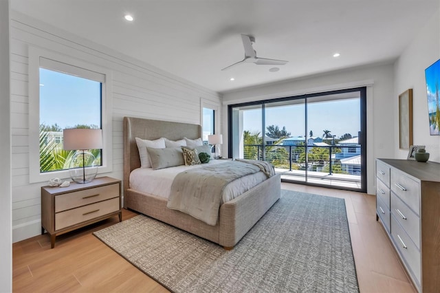 bedroom with access to exterior, light hardwood / wood-style floors, and ceiling fan