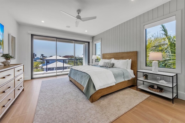 bedroom with access to outside, light hardwood / wood-style floors, and ceiling fan