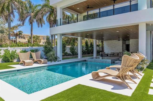 view of pool with a patio and ceiling fan