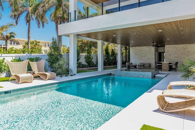 view of swimming pool featuring ceiling fan and a patio area
