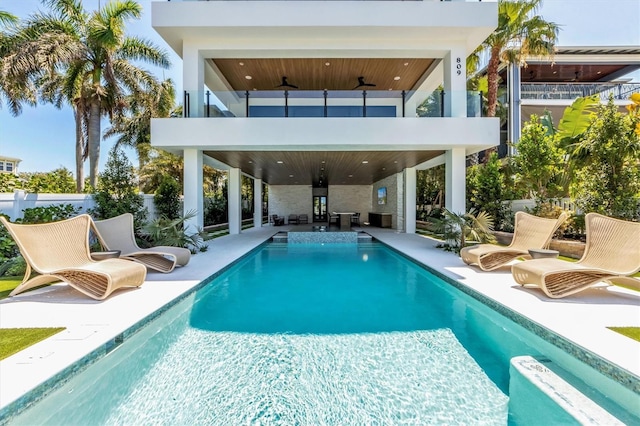 view of swimming pool with a patio and ceiling fan