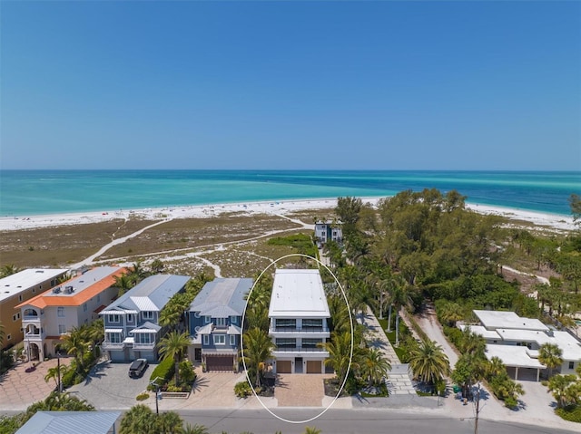 bird's eye view featuring a water view and a view of the beach