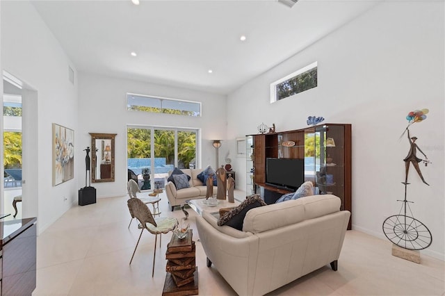 tiled living room with a high ceiling