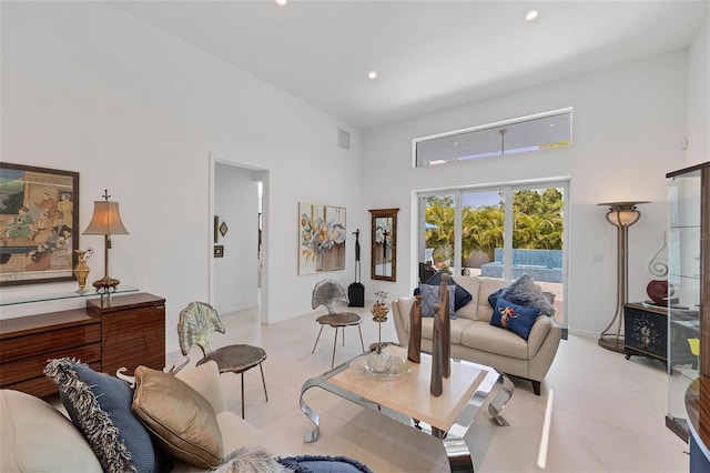 tiled living room featuring a towering ceiling