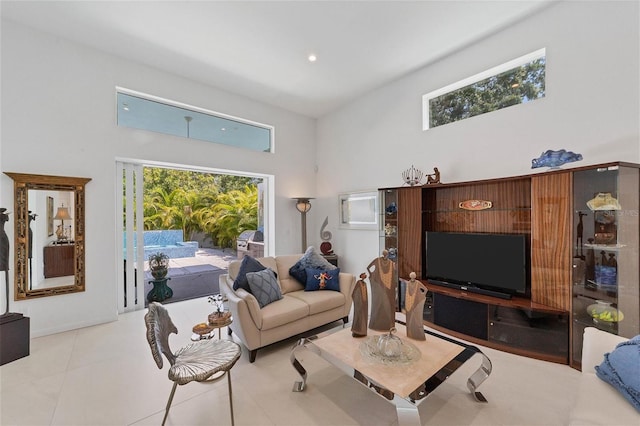 living room featuring a high ceiling and light tile flooring