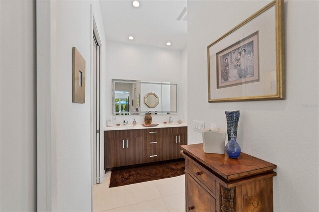 bathroom with vanity with extensive cabinet space and tile floors