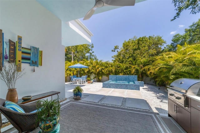 view of patio with an outdoor hot tub and a grill