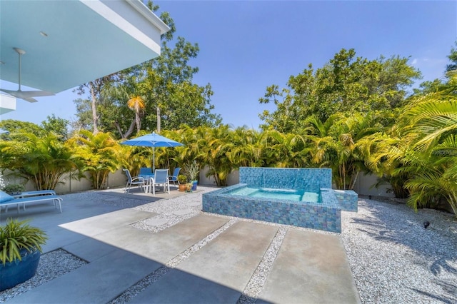 view of swimming pool featuring an outdoor hot tub and a patio area