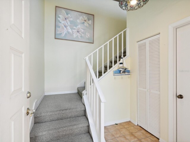 stairway featuring light tile floors