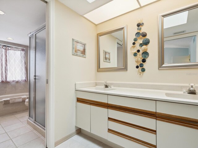 bathroom with double vanity, toilet, and tile floors