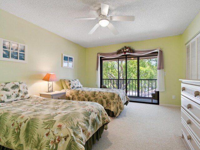 carpeted bedroom with a closet, a textured ceiling, ceiling fan, and access to exterior