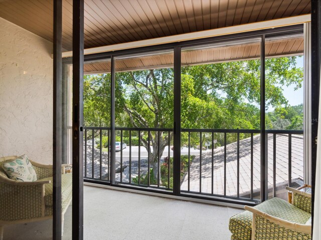 sunroom / solarium with wood ceiling and a healthy amount of sunlight