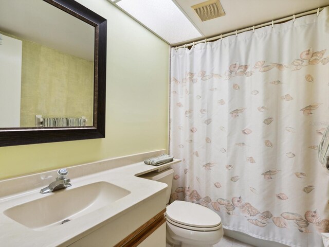 bathroom featuring toilet and vanity