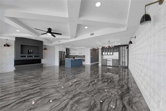 interior space with a kitchen island, hanging light fixtures, ceiling fan with notable chandelier, coffered ceiling, and tile floors