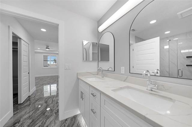 bathroom featuring vanity with extensive cabinet space, double sink, an enclosed shower, and tile flooring