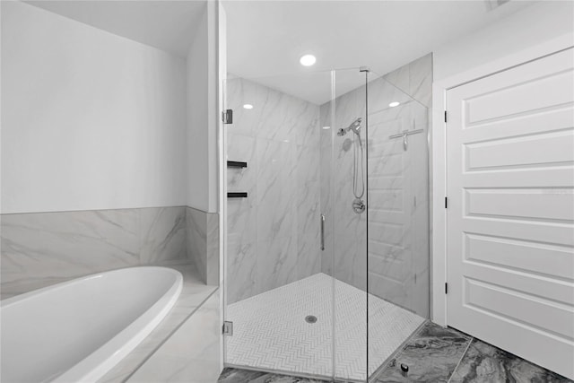 bathroom featuring independent shower and bath and tile flooring