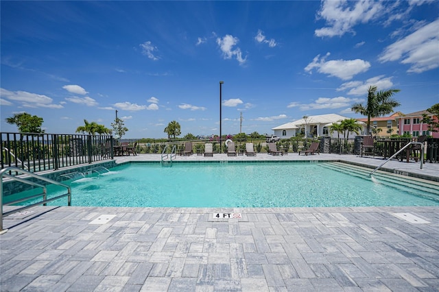 view of swimming pool featuring pool water feature