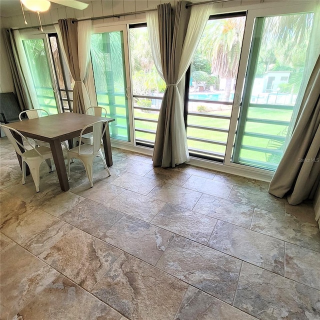 interior space featuring ceiling fan and tile floors