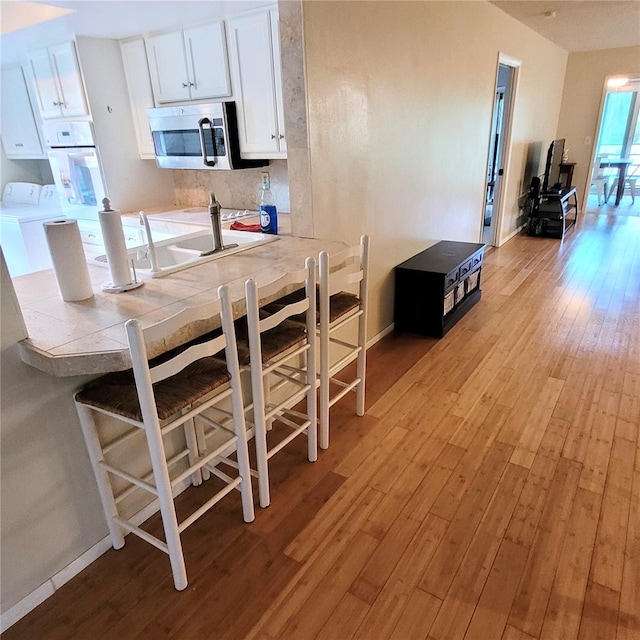 interior space with light hardwood / wood-style flooring and washer / dryer