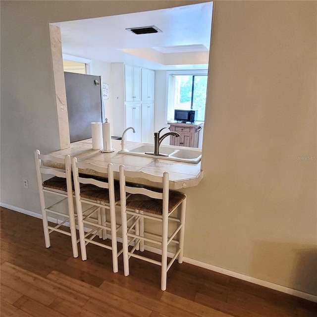 unfurnished dining area featuring dark hardwood / wood-style flooring and sink