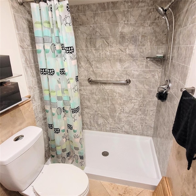 bathroom featuring tile floors, toilet, and a shower with shower curtain