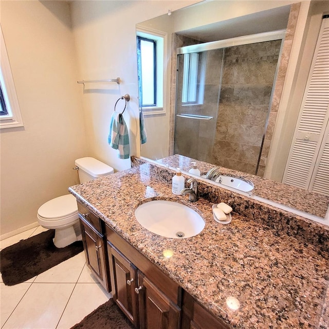 bathroom with toilet, tile flooring, and vanity