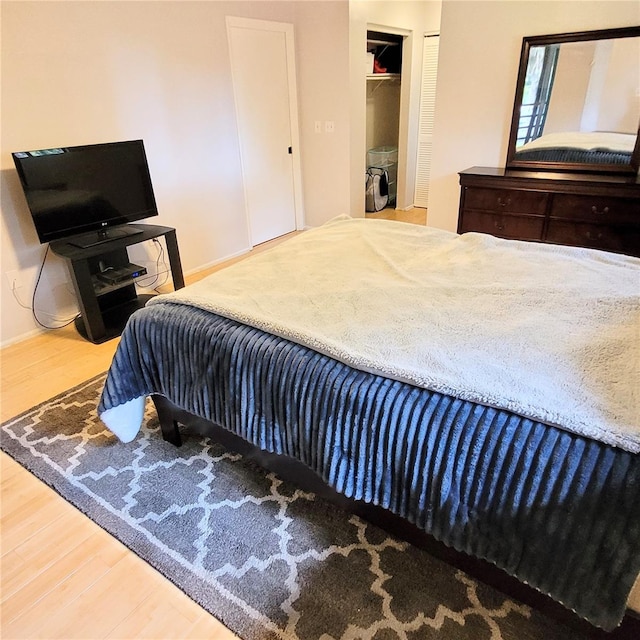 bedroom with a closet and hardwood / wood-style flooring