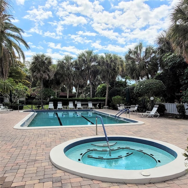 view of pool with a patio area and a community hot tub