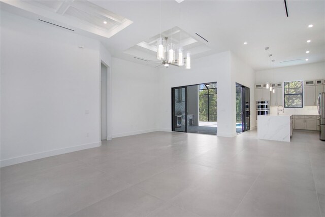 4111 Williams Rd, Estero, FL 33928 - unfurnished room with recessed lighting, a towering ceiling, a sink, coffered ceiling, and baseboards