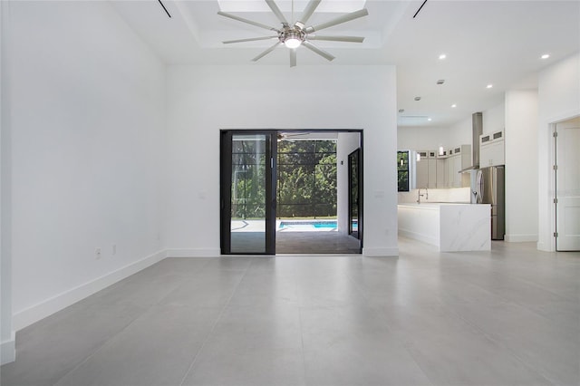 4111 Williams Rd, Estero, FL 33928 - empty room with a high ceiling, recessed lighting, a sink, and baseboards