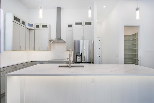 4111 Williams Rd, Estero, FL 33928 - kitchen with stainless steel refrigerator with ice dispenser, decorative backsplash, a sink, a large island with sink, and wall chimney exhaust hood