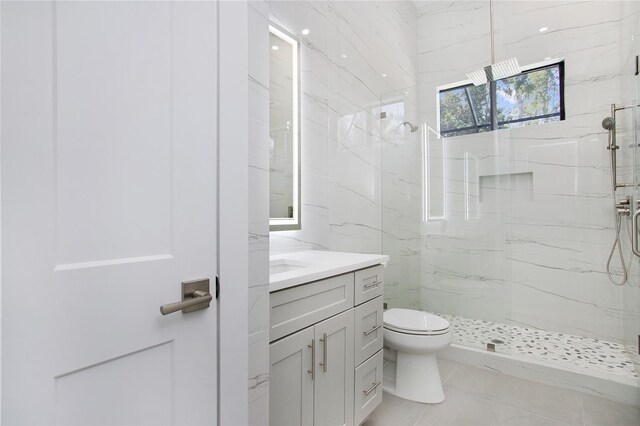 4111 Williams Rd, Estero, FL 33928 - full bathroom featuring toilet, tile patterned flooring, a marble finish shower, and vanity