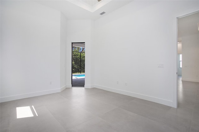 4111 Williams Rd, Estero, FL 33928 - empty room featuring a towering ceiling, visible vents, and baseboards