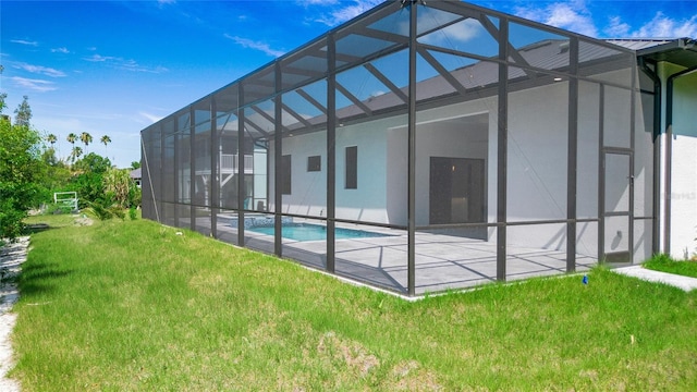 4111 Williams Rd, Estero, FL 33928 - rear view of property with an outdoor pool, a lawn, glass enclosure, metal roof, and a patio area