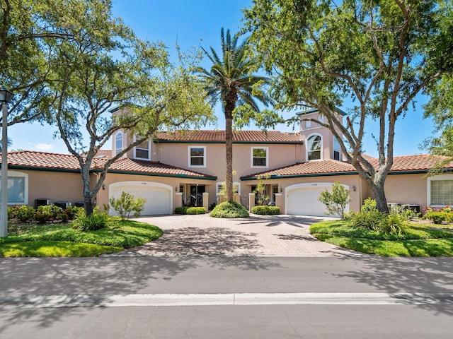 mediterranean / spanish home with a garage