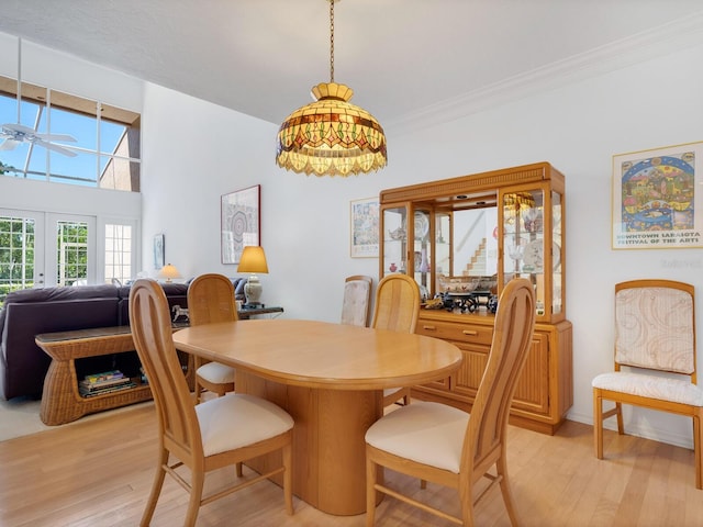 dining area featuring french doors, ceiling fan, light hardwood / wood-style floors, and crown molding