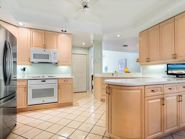 kitchen featuring light brown cabinetry, white appliances, ceiling fan, and light tile floors