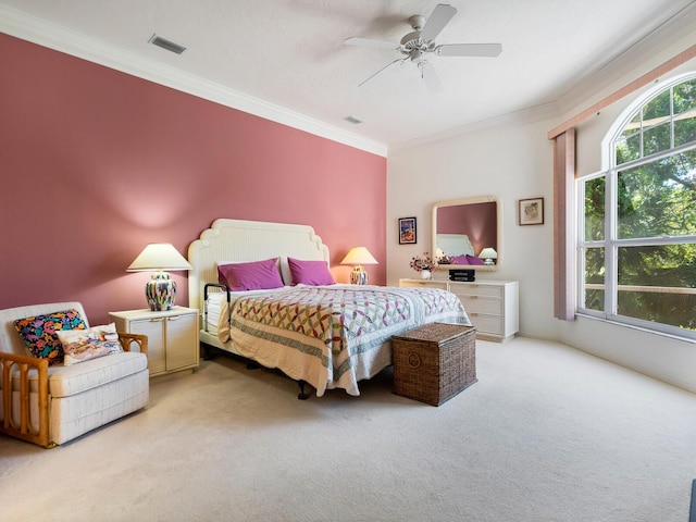 carpeted bedroom featuring ornamental molding and ceiling fan