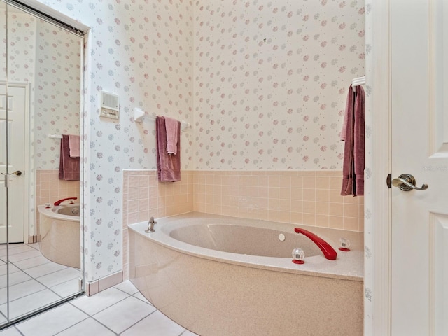 bathroom featuring tile flooring and a bathing tub