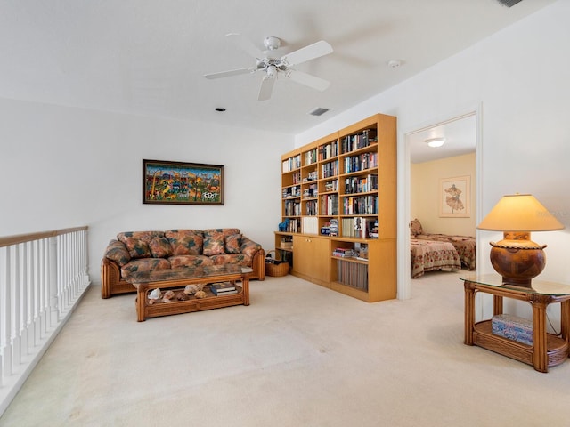 sitting room featuring ceiling fan and carpet flooring