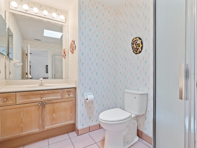 bathroom with vanity with extensive cabinet space, tile floors, and toilet