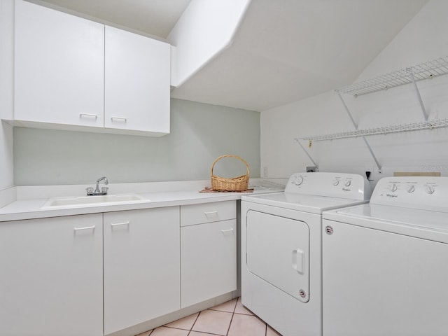 laundry area featuring washing machine and dryer, cabinets, electric dryer hookup, sink, and light tile floors