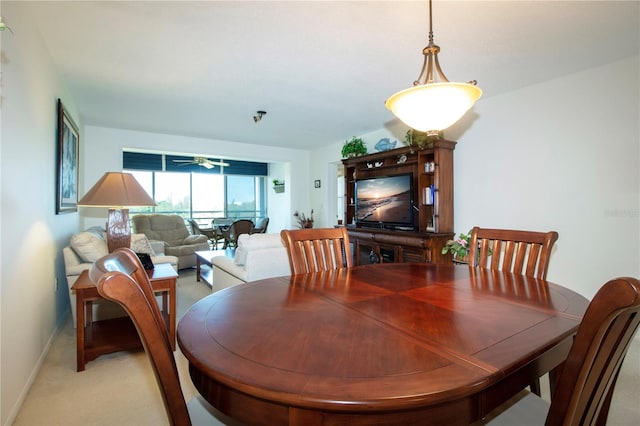 dining room featuring ceiling fan and light carpet