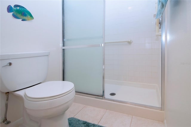 bathroom featuring toilet, tile patterned floors, and walk in shower