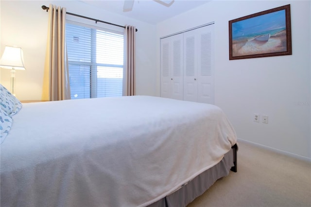 carpeted bedroom with a closet and ceiling fan